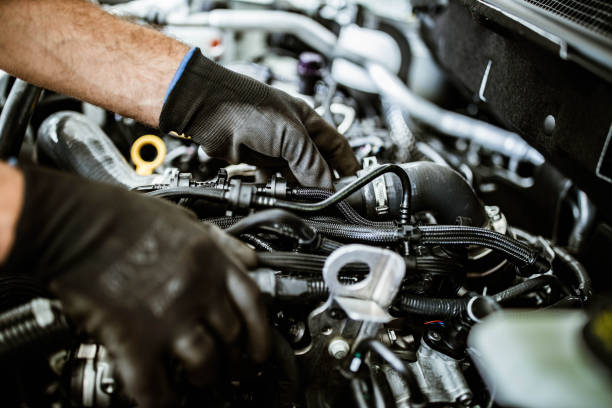 Close up of unrecognizable car mechanic working on a car pump at workshop. Close up of unrecognizable car mechanic working on a car pump at workshop.