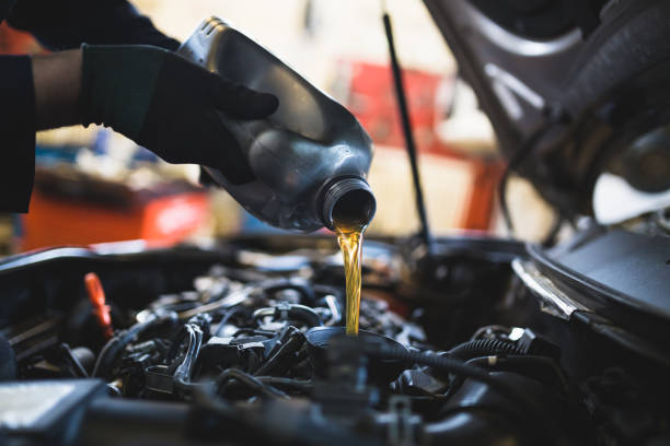 Close up hands of unrecognizable mechanic doing car service and maintenance. Close up hands of unrecognizable mechanic doing car service and maintenance.